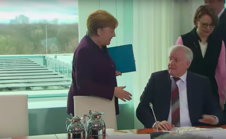 Меркель и министр внутренних дел Германии